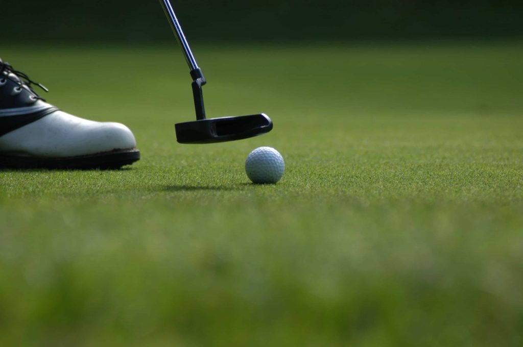 Closeup of a golfer putting 